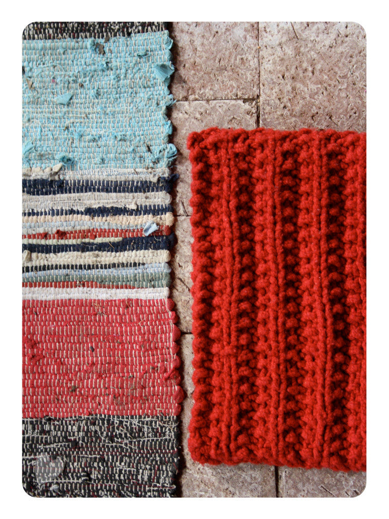 A chunky knitted cowl on the floor