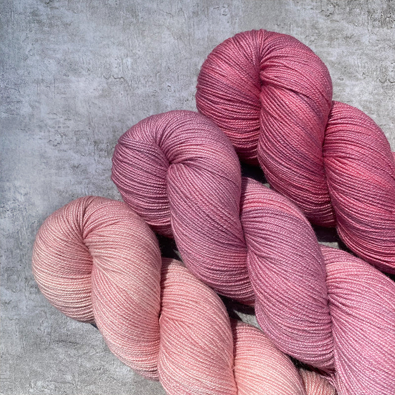 Three skeins of coordination pink hand dyed yarns.