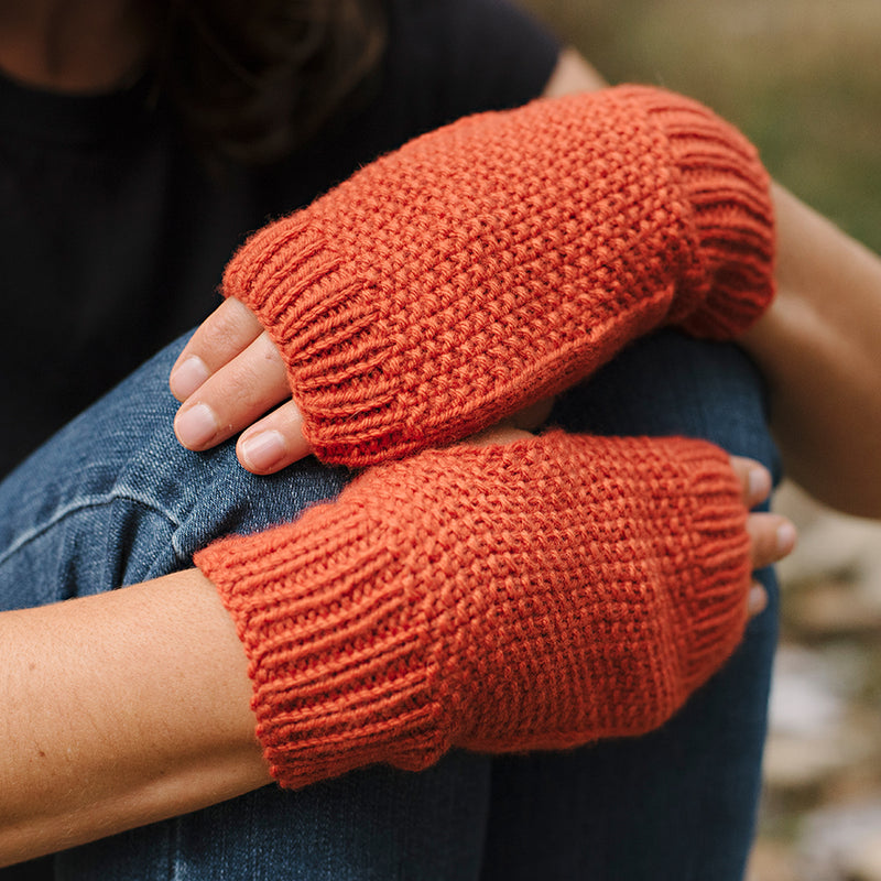 close up of hands wearing fingerless mitts